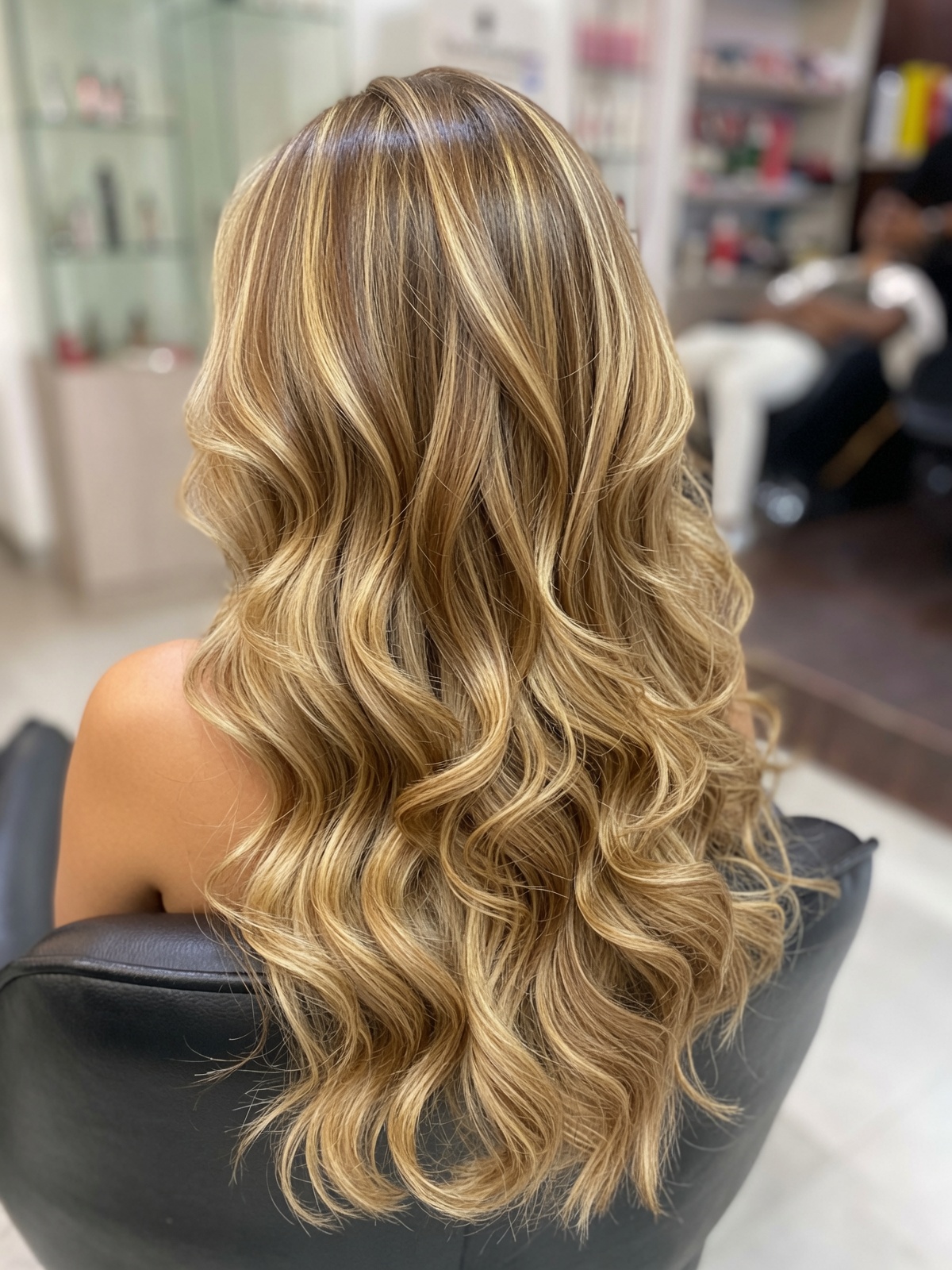 Dimensional blonde highlights styled in long waves