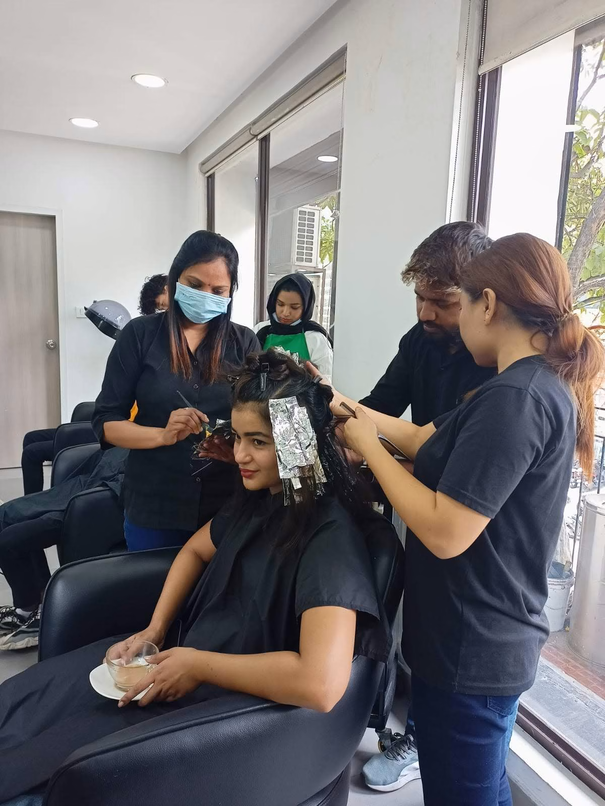 The Salon Nayana team applying professional hair colour