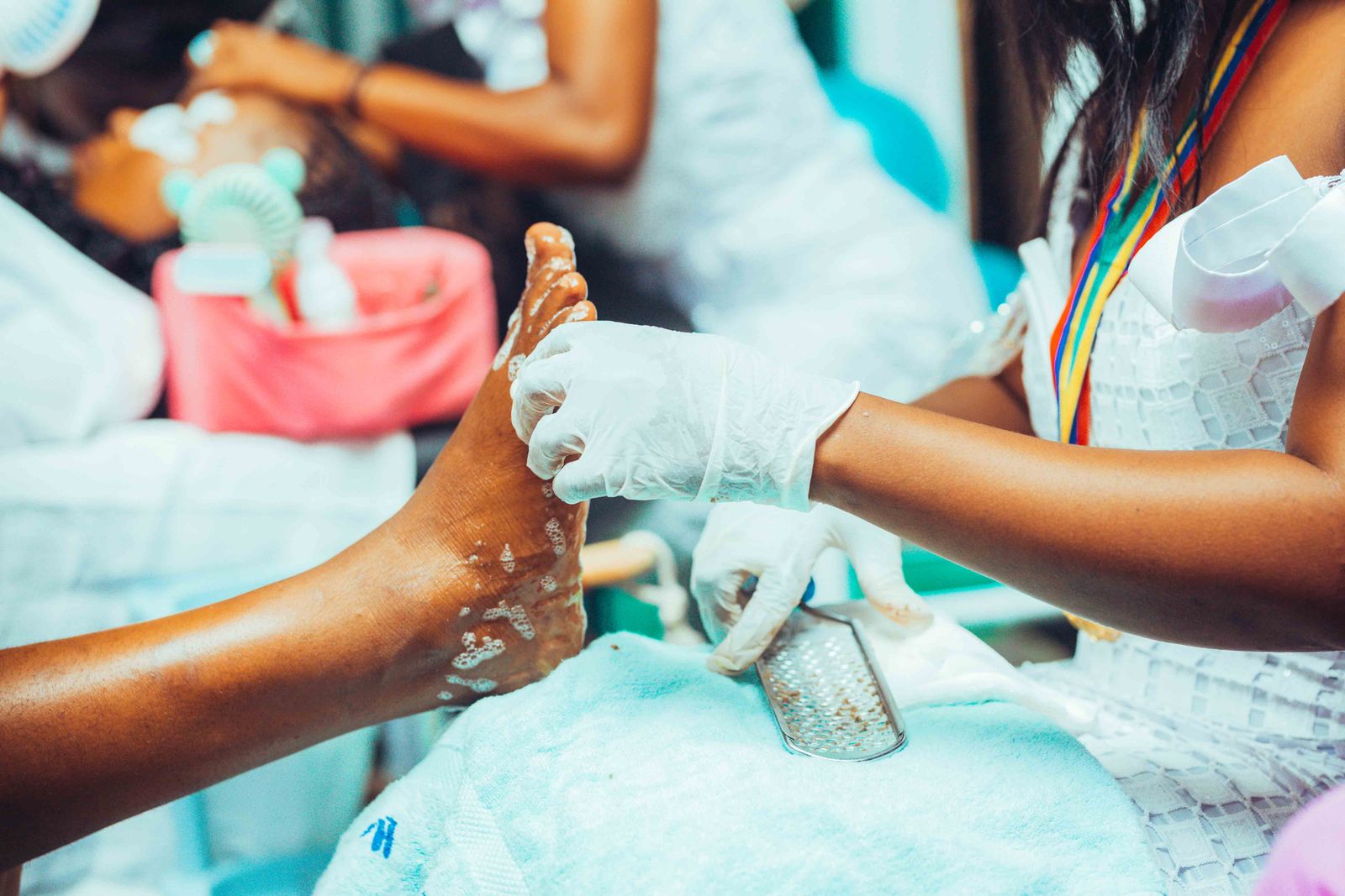 A beauty professional carrying out a pedicure treatment